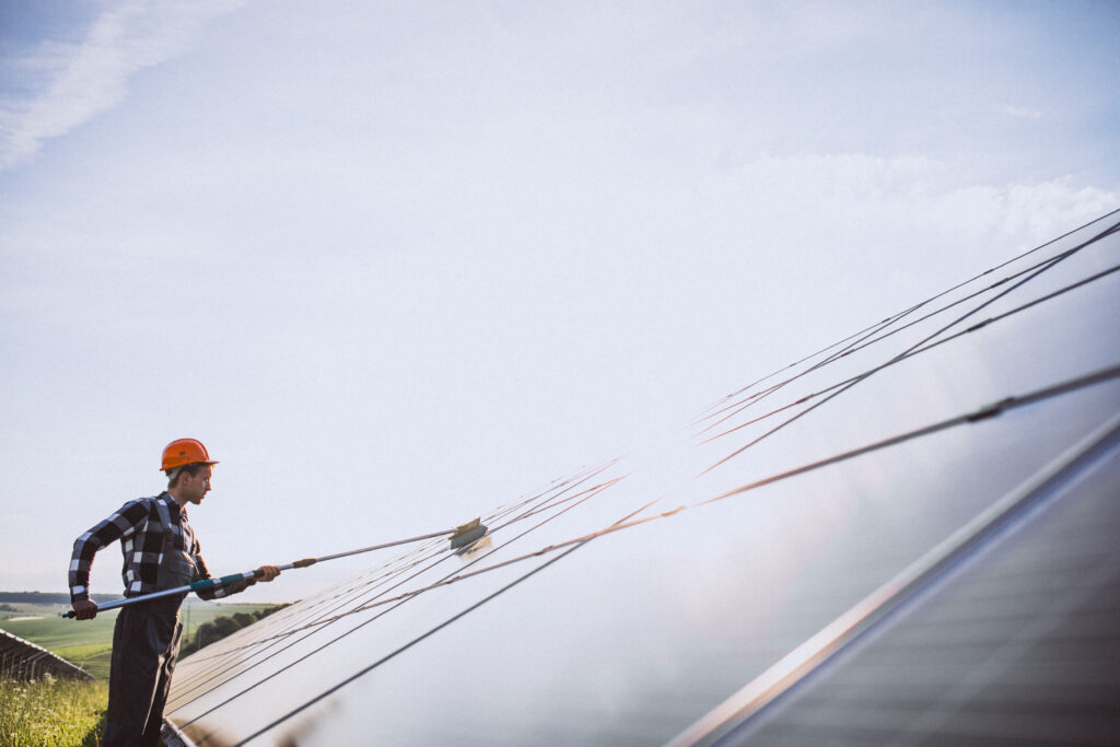 man worker firld by solar panels